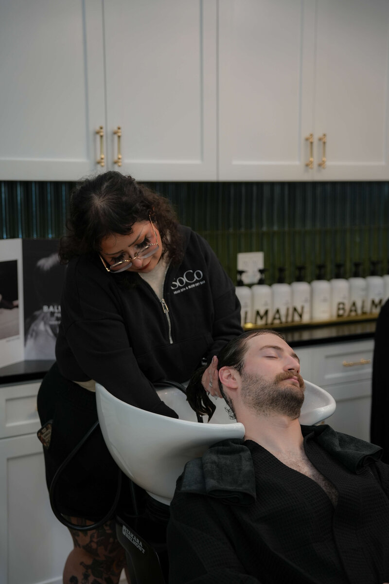 A guest receiving a customized scalp facial treatment at SoCo Head Spa in Bryan, TX.