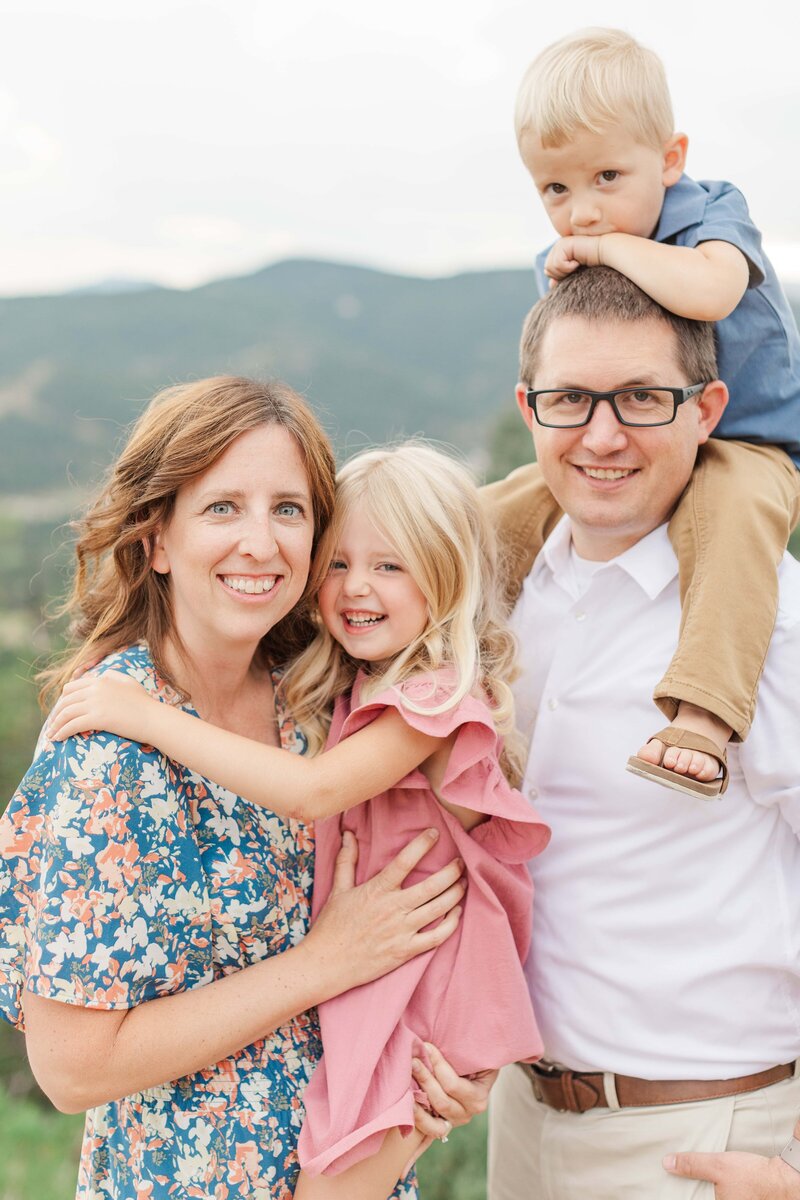 Family looking at camera at Mt. Falcon  in Morrison, CO