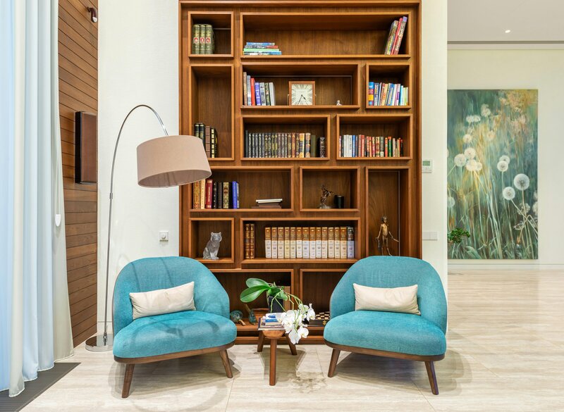 Photo by Max Vakhtbovycn: https://www.pexels.com/photo/living-room-with-cozy-chairs-near-lamp-and-wooden-bookcase-7195289/