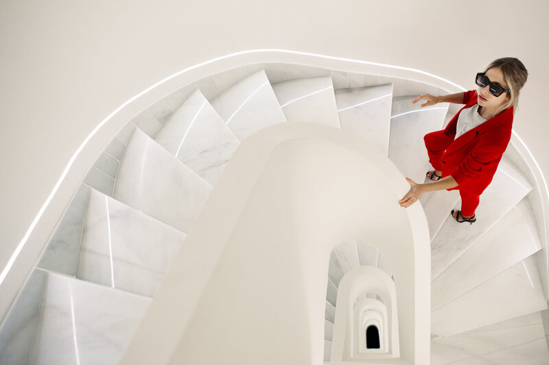 a-woman-dressed-in-a-red-suit-and-sunglasses-ascen-2025-01-08-23-19-46-utc