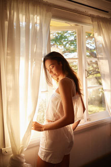 Model in white pj set in cottage