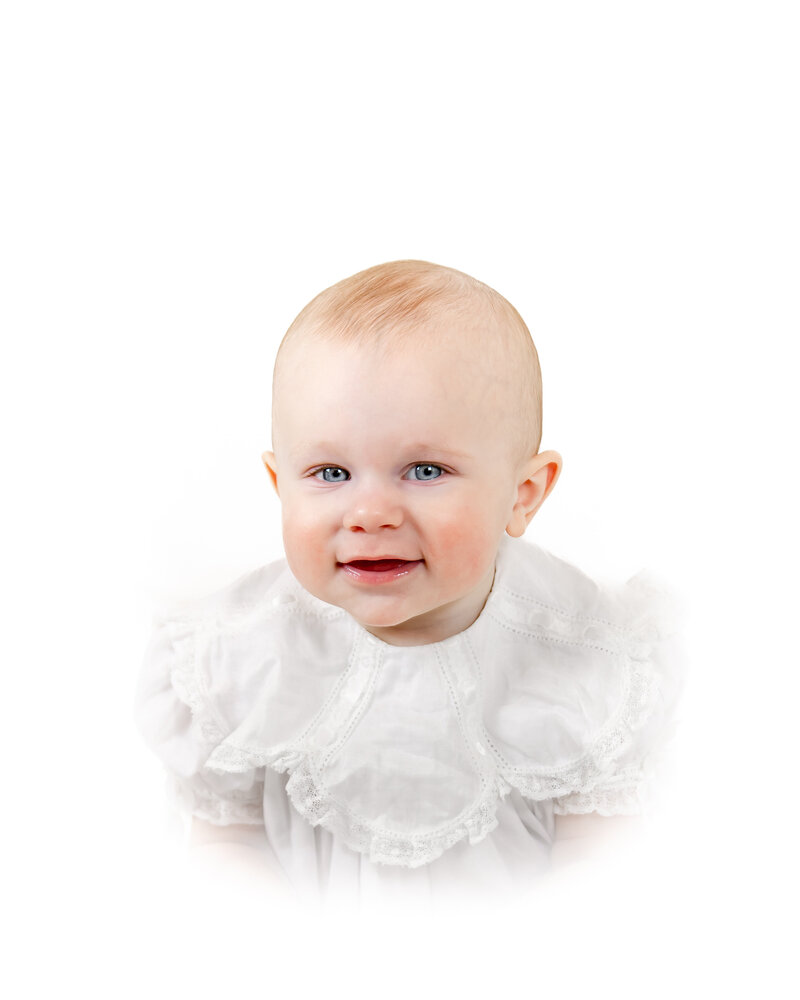 A classic heirloom children's portrait featuring a young toddler with golden hair and bright blue eyes, dressed in a traditional light blue outfit. Timeless children's photography with a soft, painterly background.