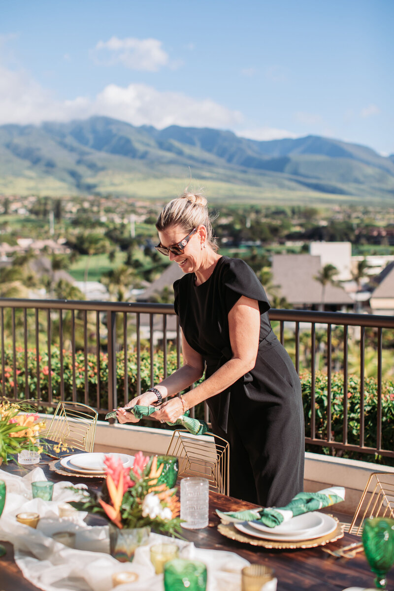 wedding planner setting up with view of Maui in background