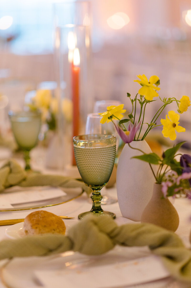 Tablescape with small floral details of the small pieces with just a few flowers.