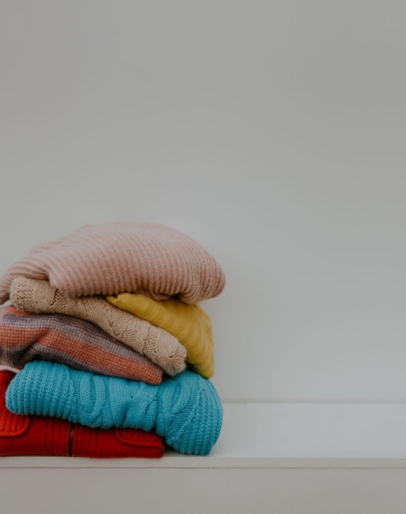 A stack of colorful sweaters 