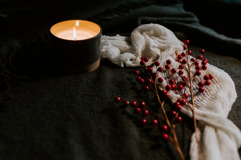 Lit candle and white scarf