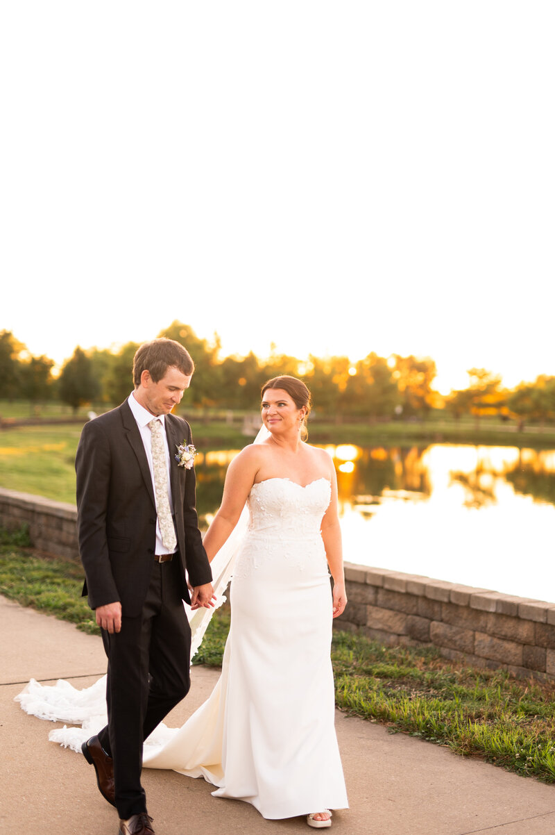Bride and groom embraced and kissing outside