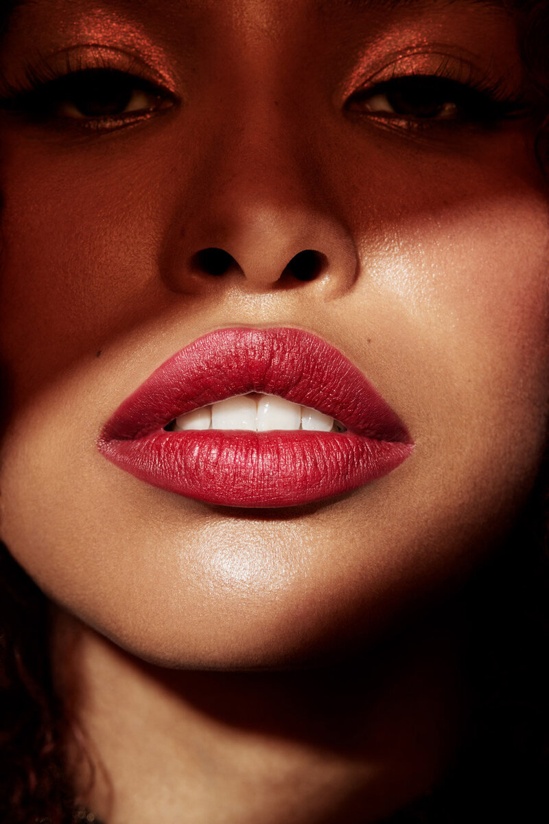 Close-up of Jazz Walters with glossy red lips, highlighting bold makeup, captured by Ylva Erevall.