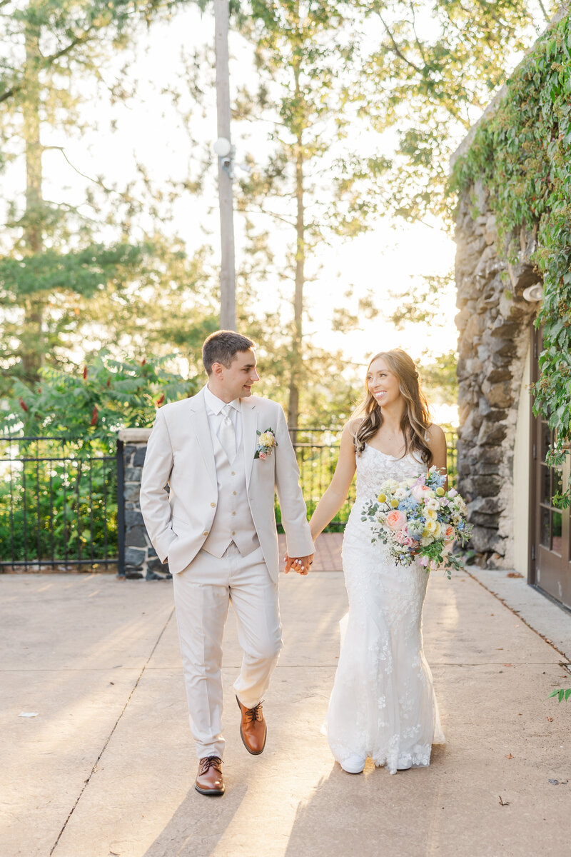 bride and groom walking while holding hands