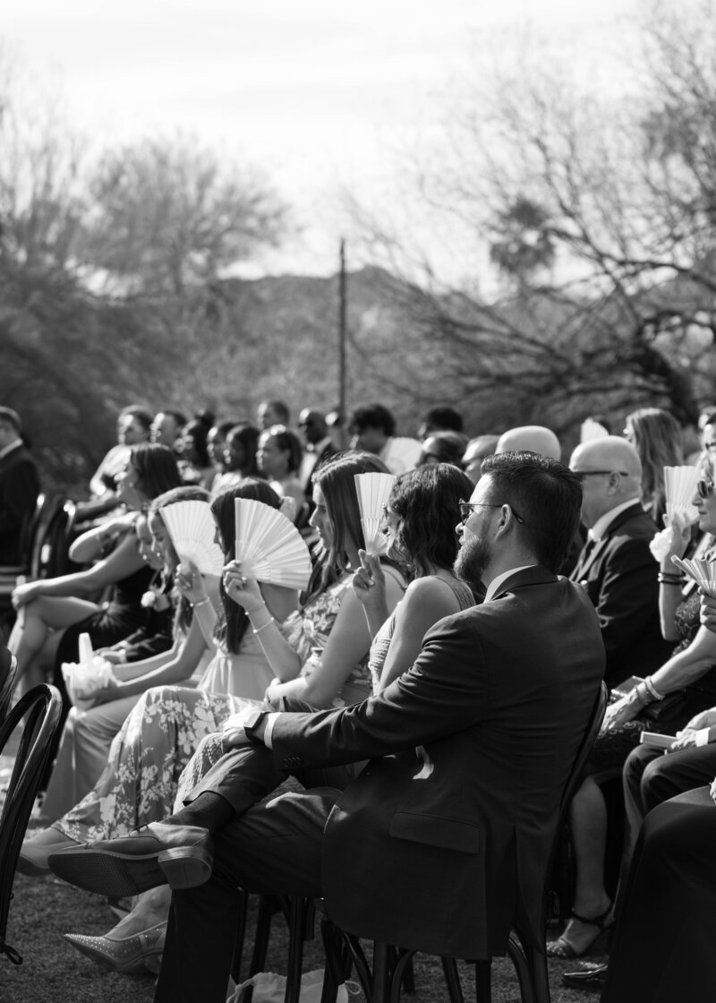 Guests watch bride and groom exchange vows at El Chorro, a wedding venue in Paradise Valley, Arizona. 