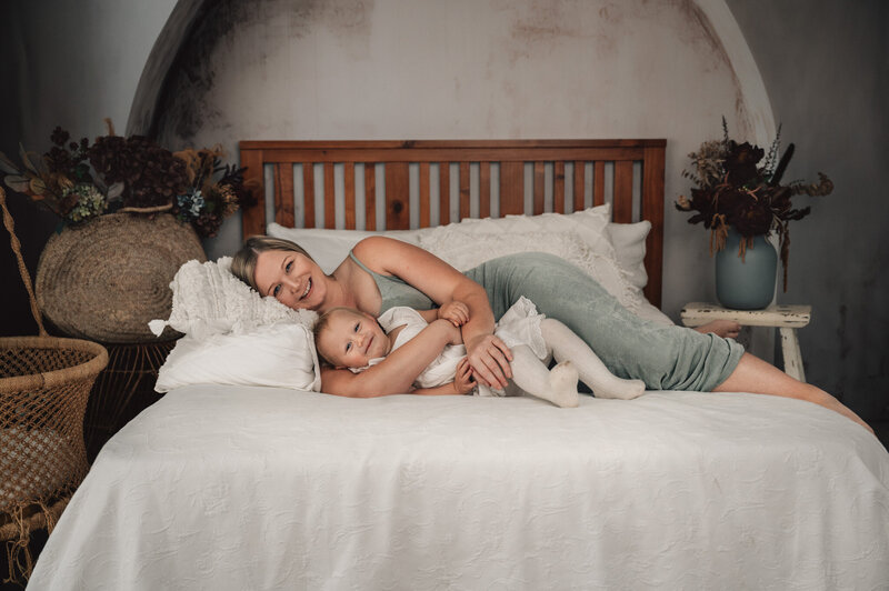 expecting mother in studio shoot, maori tatoo on leg in black bra and jacket