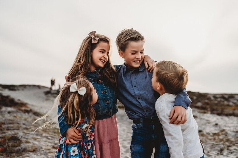 San Diego Maternity Photographer captures family playing together on beach during outdoor family photos