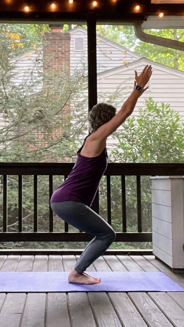 Karen demonstrating a standing yoga pose suitable for individuals with knee discomfort.