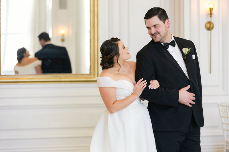 Close up of bride and groom standing together in the Governor’s Room at The Adolphus in Dallas, looking at each other in a simple and timeless portrait that reflects the style of weddings at this venue.