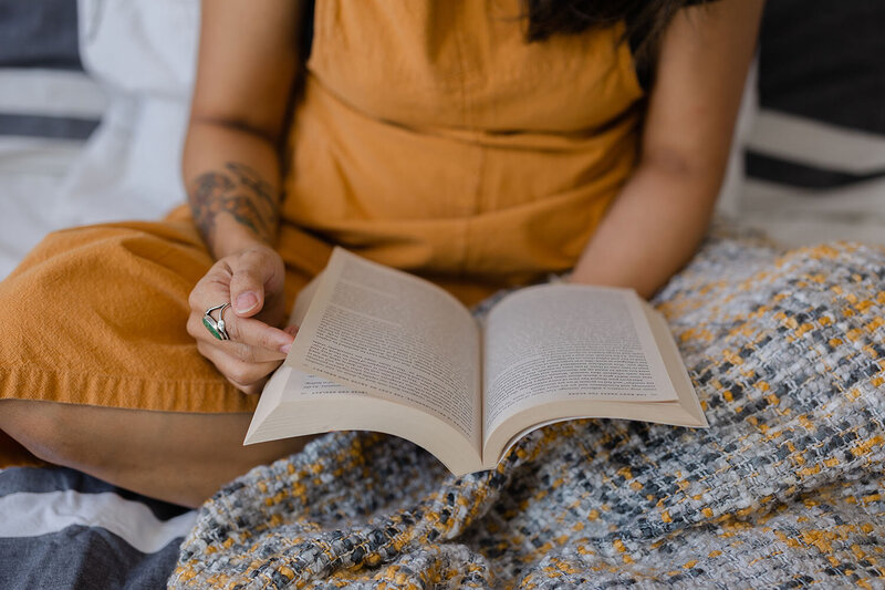 Woman reading a book during branding session in Ashburn, Virginia