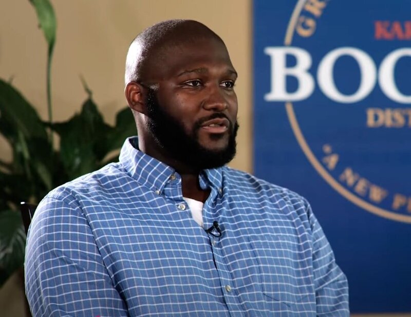 A person sitting down being interviewed 