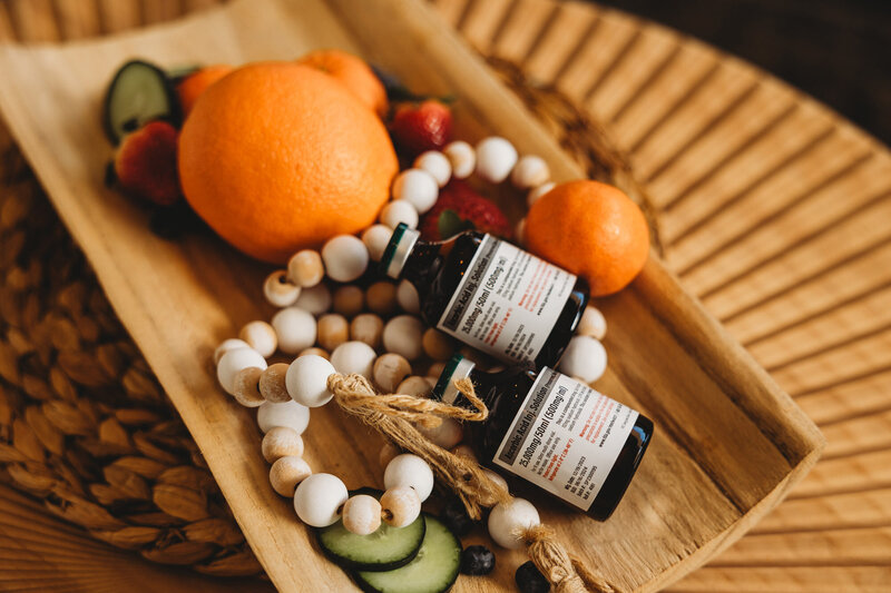 Vials of vitamins sitting in a wood dish