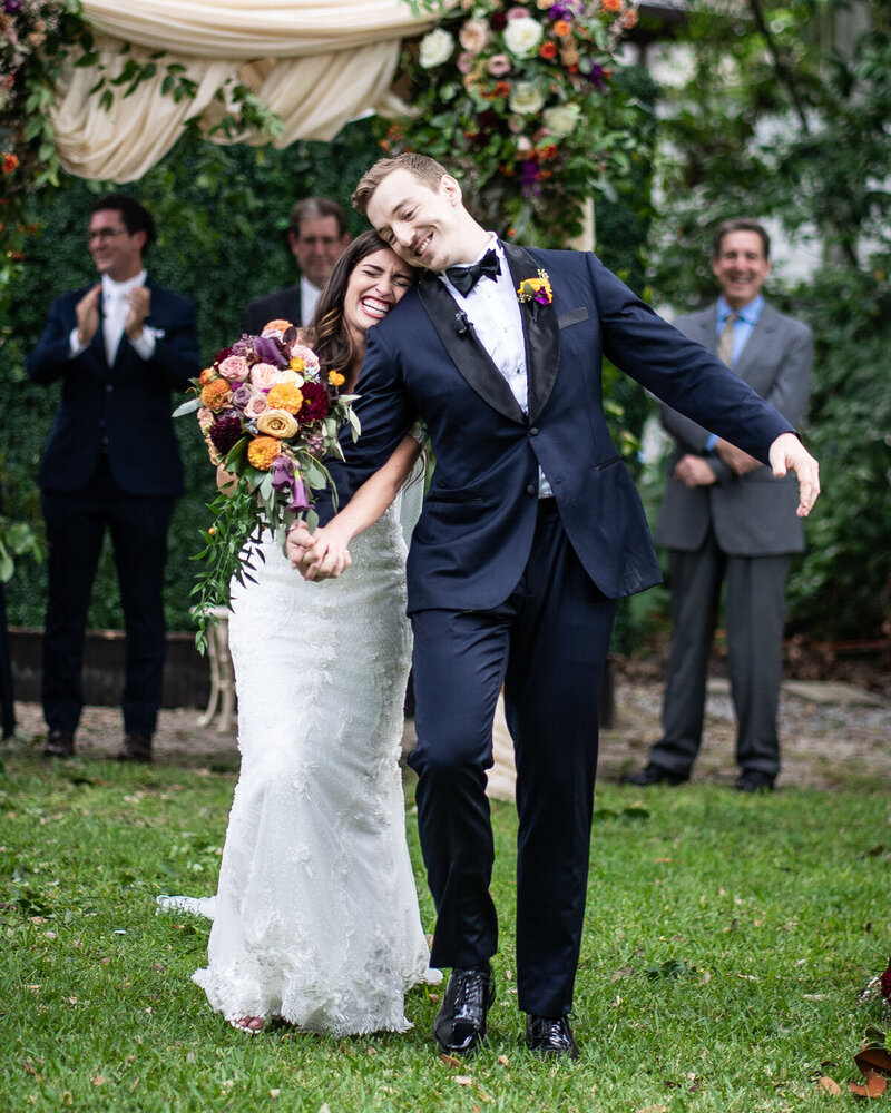 Couple laughs and smiles at the end of Elms Mansion New Orleans wedding ceremony