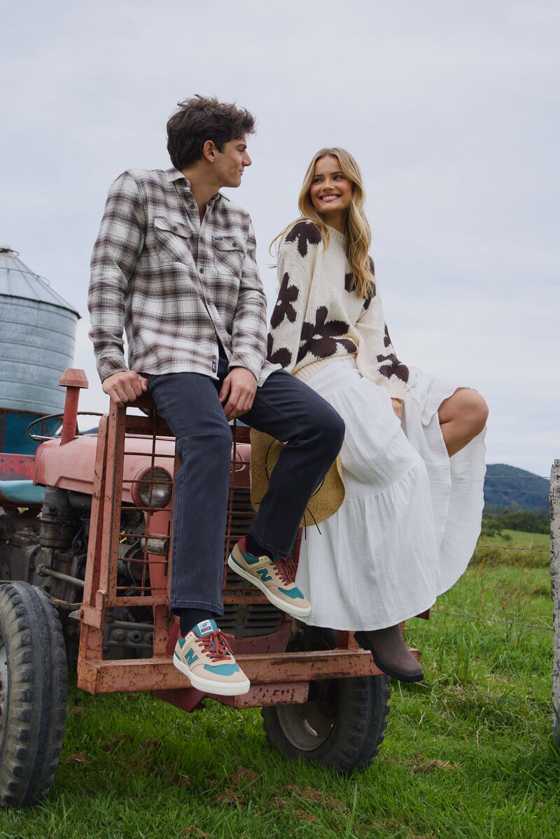 Couple sitting on vintage tractor 