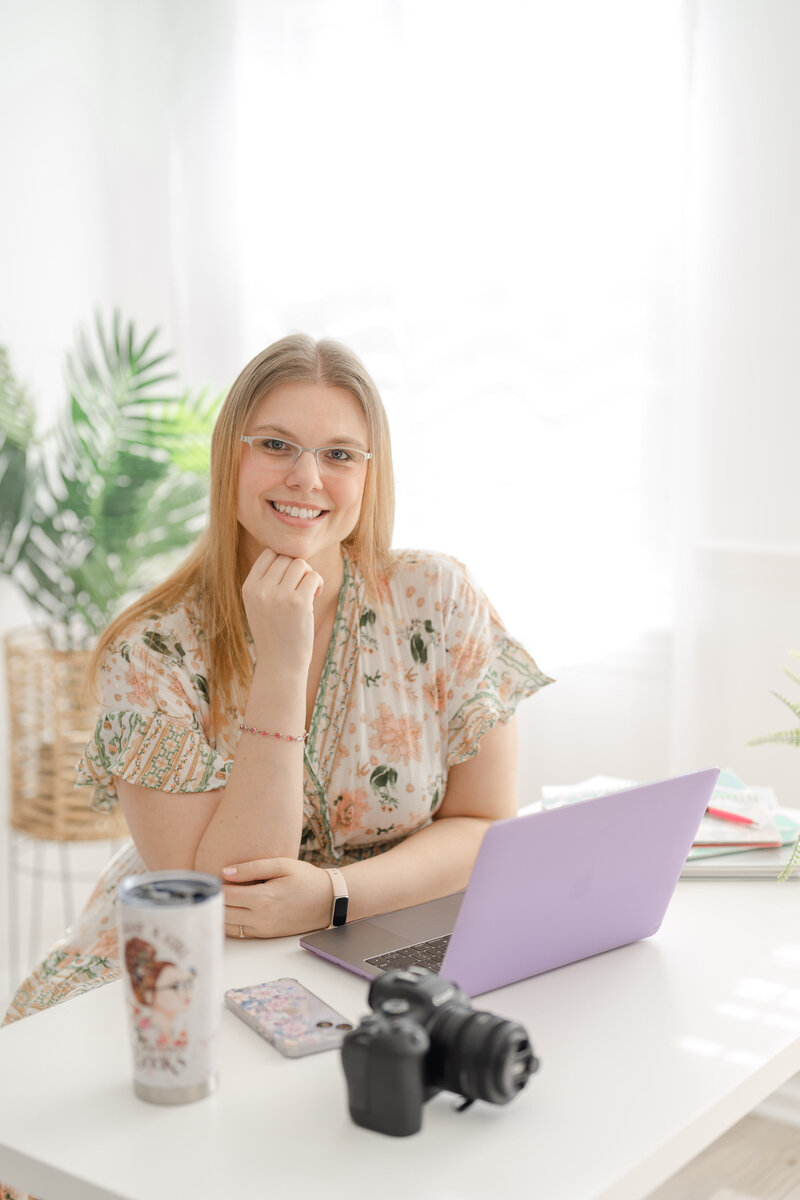 Woman posing on a working desk taken by a Manassas, VA branding photographer