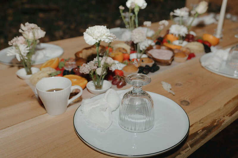 Rustic wooden table with charcuterie and flower details