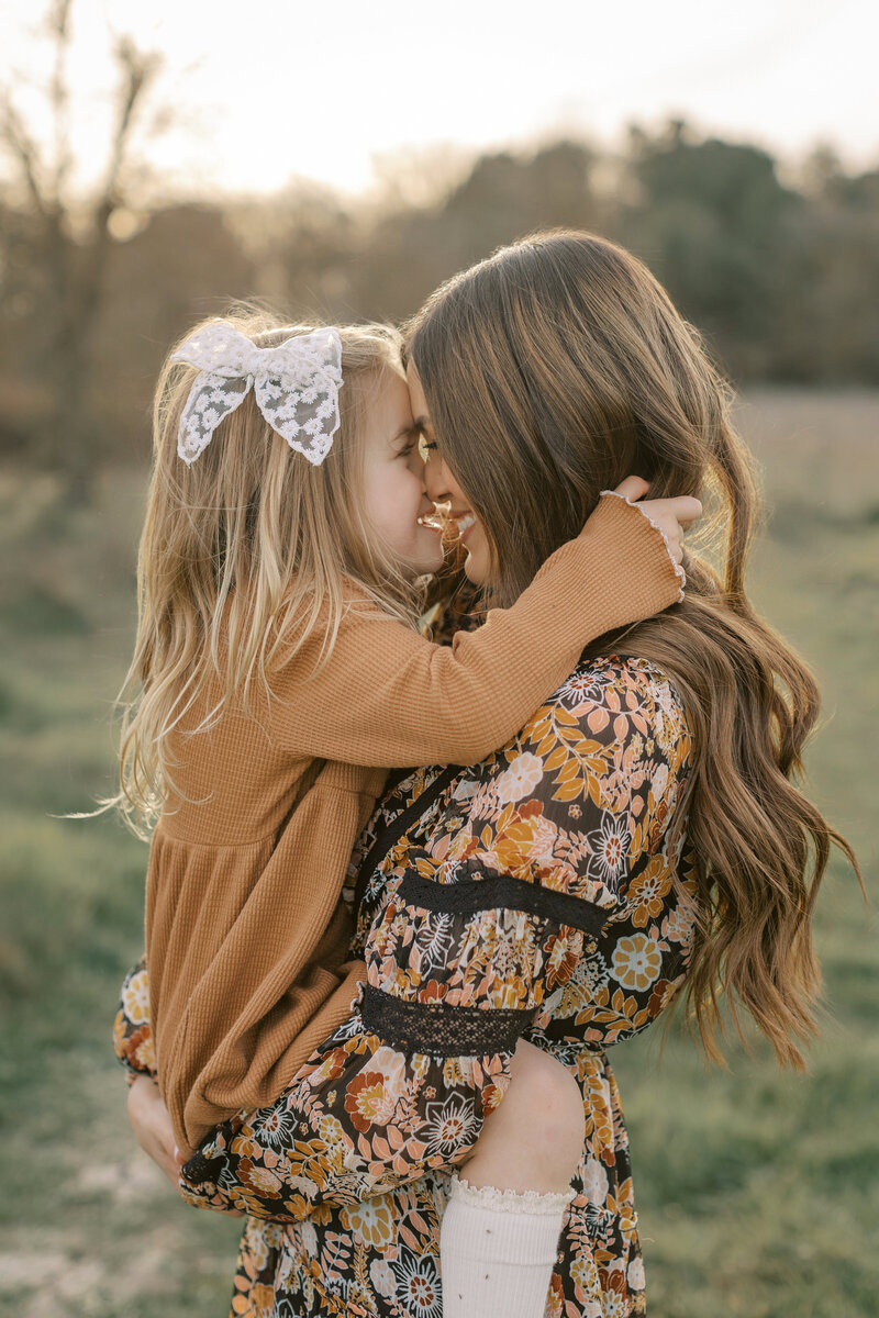girl in field, rylee and cru clothing, looking at camera, windblown hair