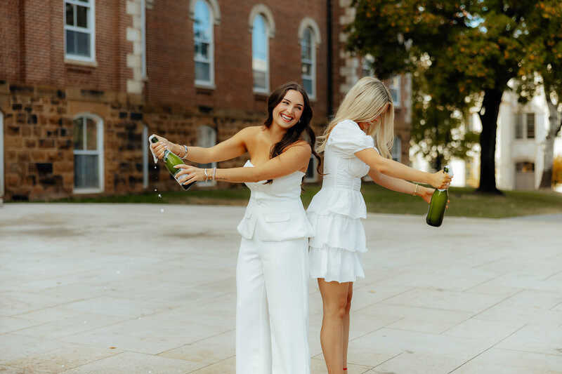 fun photo of college graduate popping some bubbly and celebrating!