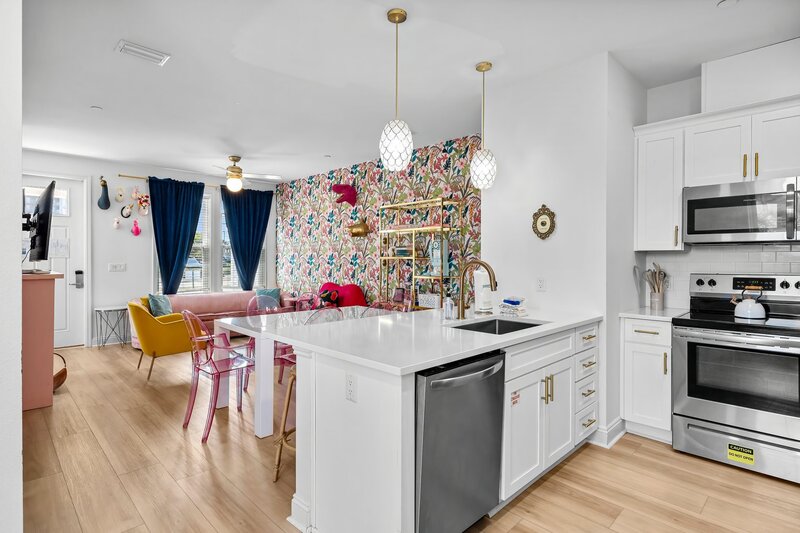 Stylish kitchen island with view into dining and living areas, ideal for social cooking and group meals near 30A and Destin.