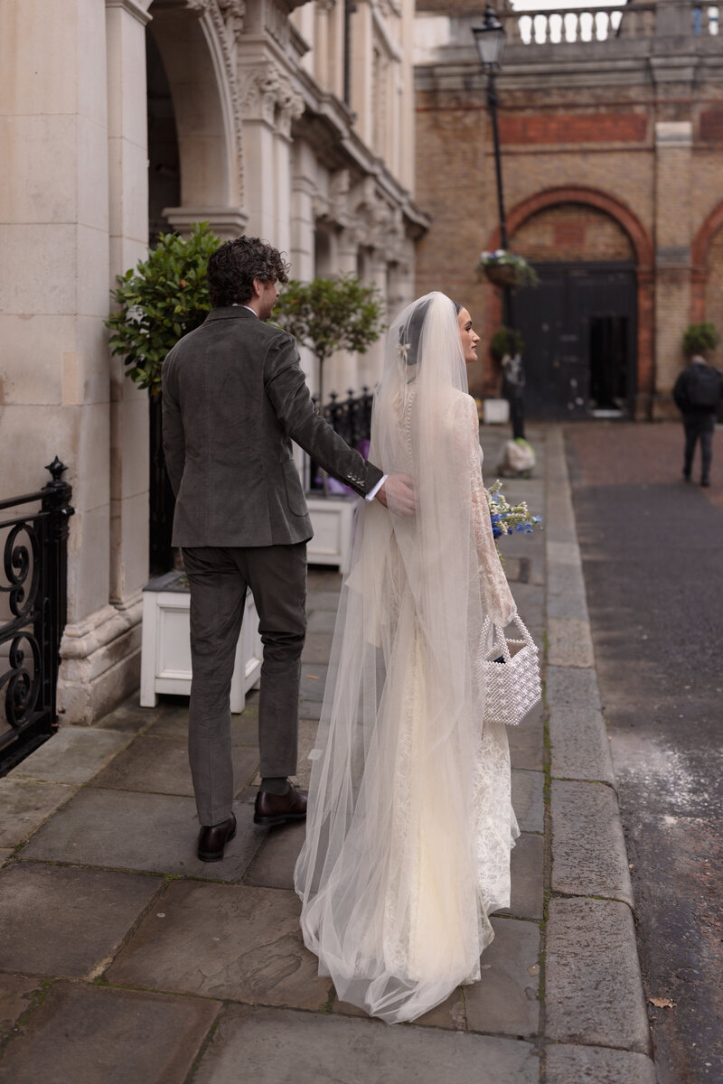 bride illuminated by golden sunlight inside her wedding ceremony at st etheldreda's chuch london
