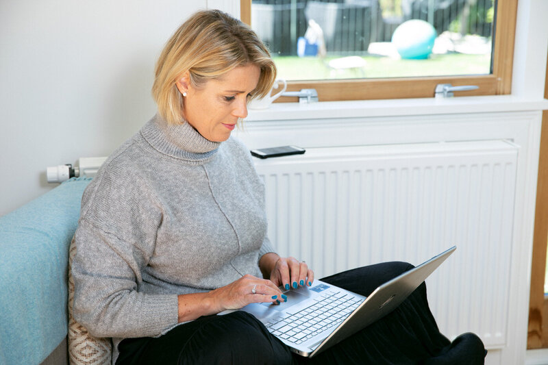 Woman working from home in her lounge on her computer