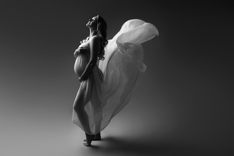 Fine art maternity silhouette by Austin photographer showcasing pregnant belly in black and white