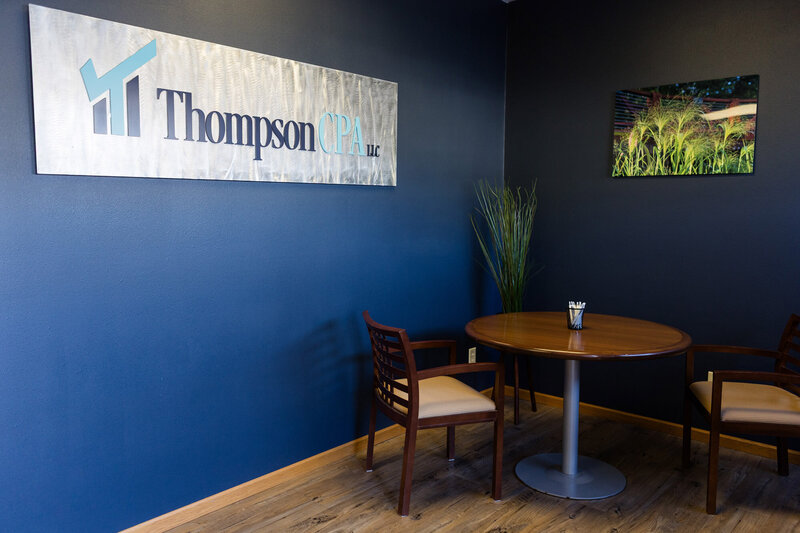 Metal sign with the Thompson CPA LLC logo printed on it