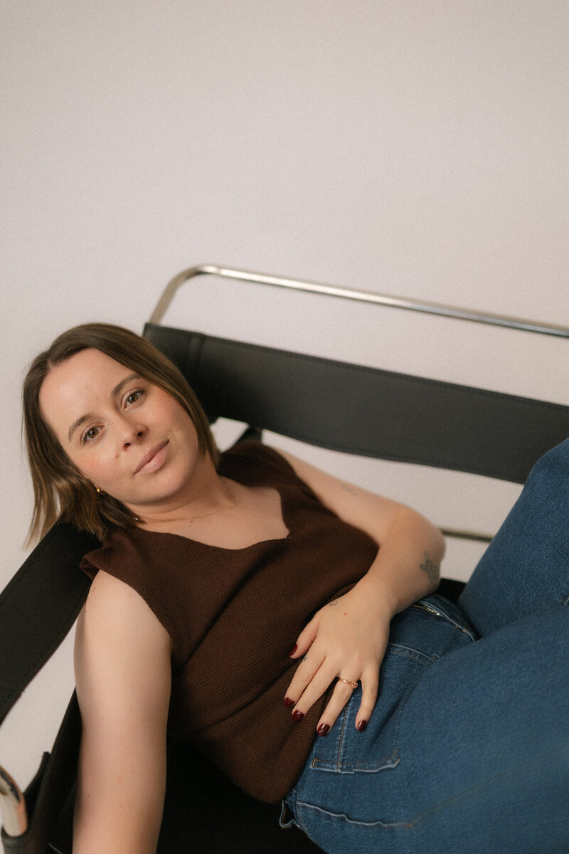 Liv Rollings sitting in cream colored chair