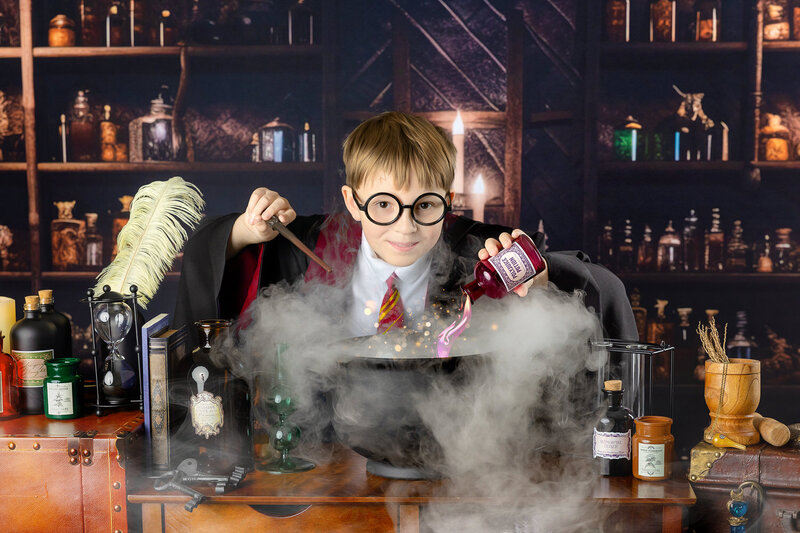 A young boy mixes potions at the Wizarding School Portrait event in Myrtle Beach, SC