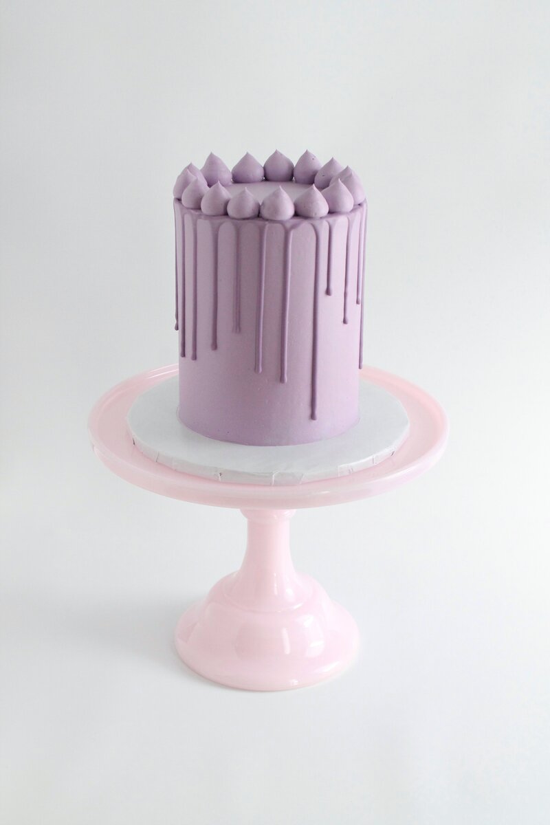 Pink cake with frosting and gold butterflies