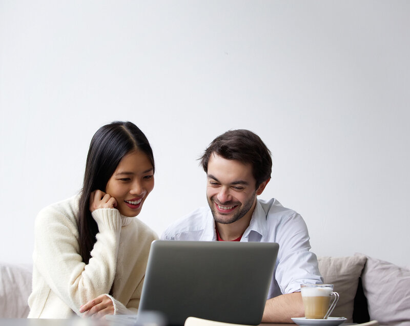 a couple in front of a laptop