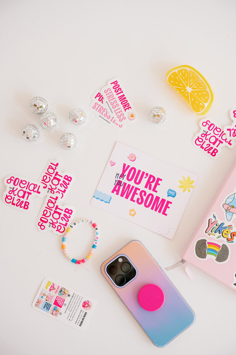 Hand putting up a blue sticky note on a collage wall