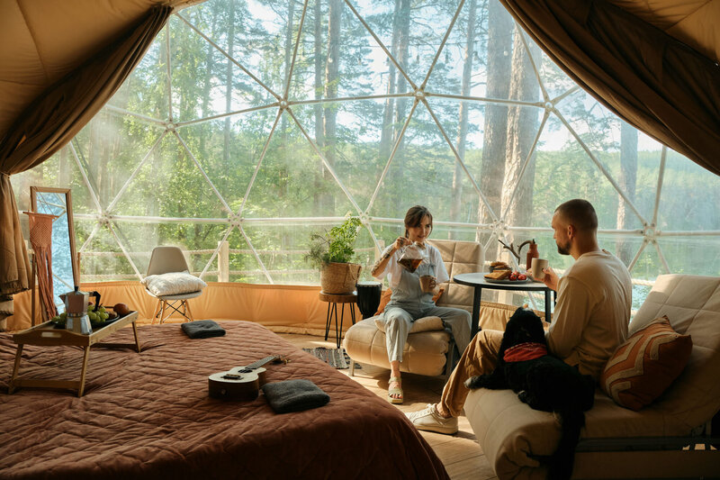 Man and woman are sitting on a couch in a living room.
