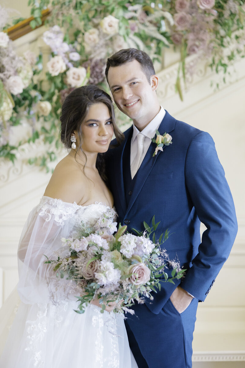 Bride and groom stand together at the Cairnwood Estate