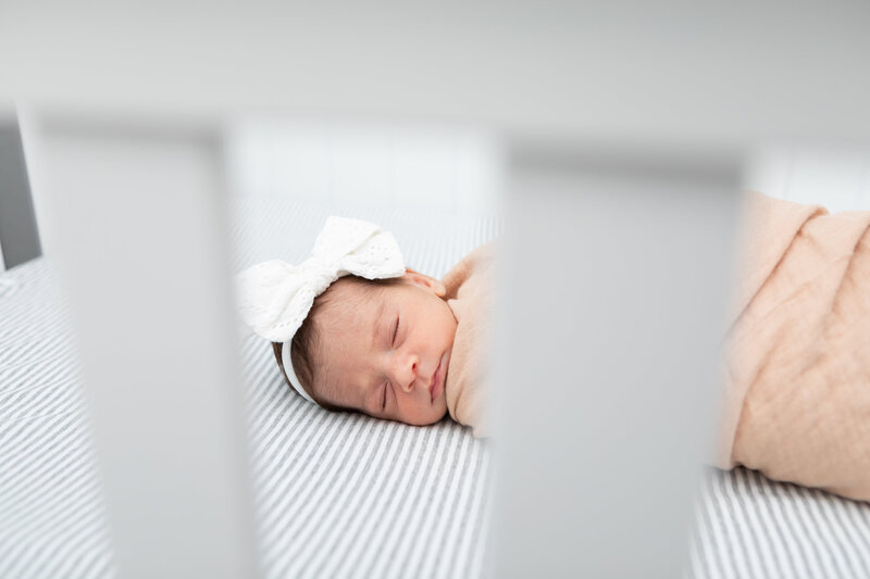 Photo of newborn baby  laying in crib