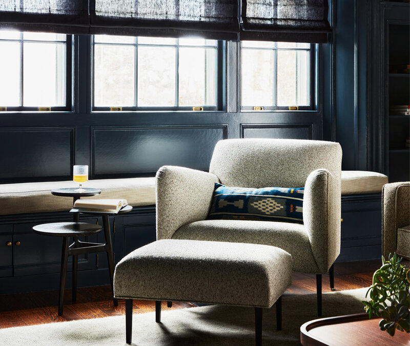 Historic home design in Boston navy blue family room features modern furniture selected by a Concord interior designer, blending classic architecture with updated style.