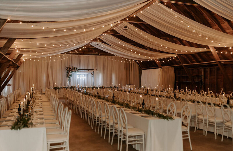 bride and groom dancing under a tent with lanterns