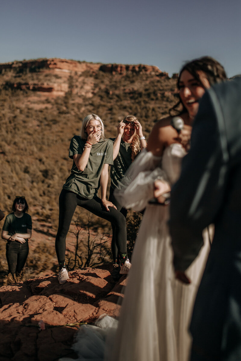 brides sisters laughing during vows