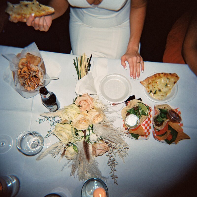 Bride with wedding food by 35mm film wedding photographer Noble Photo Co