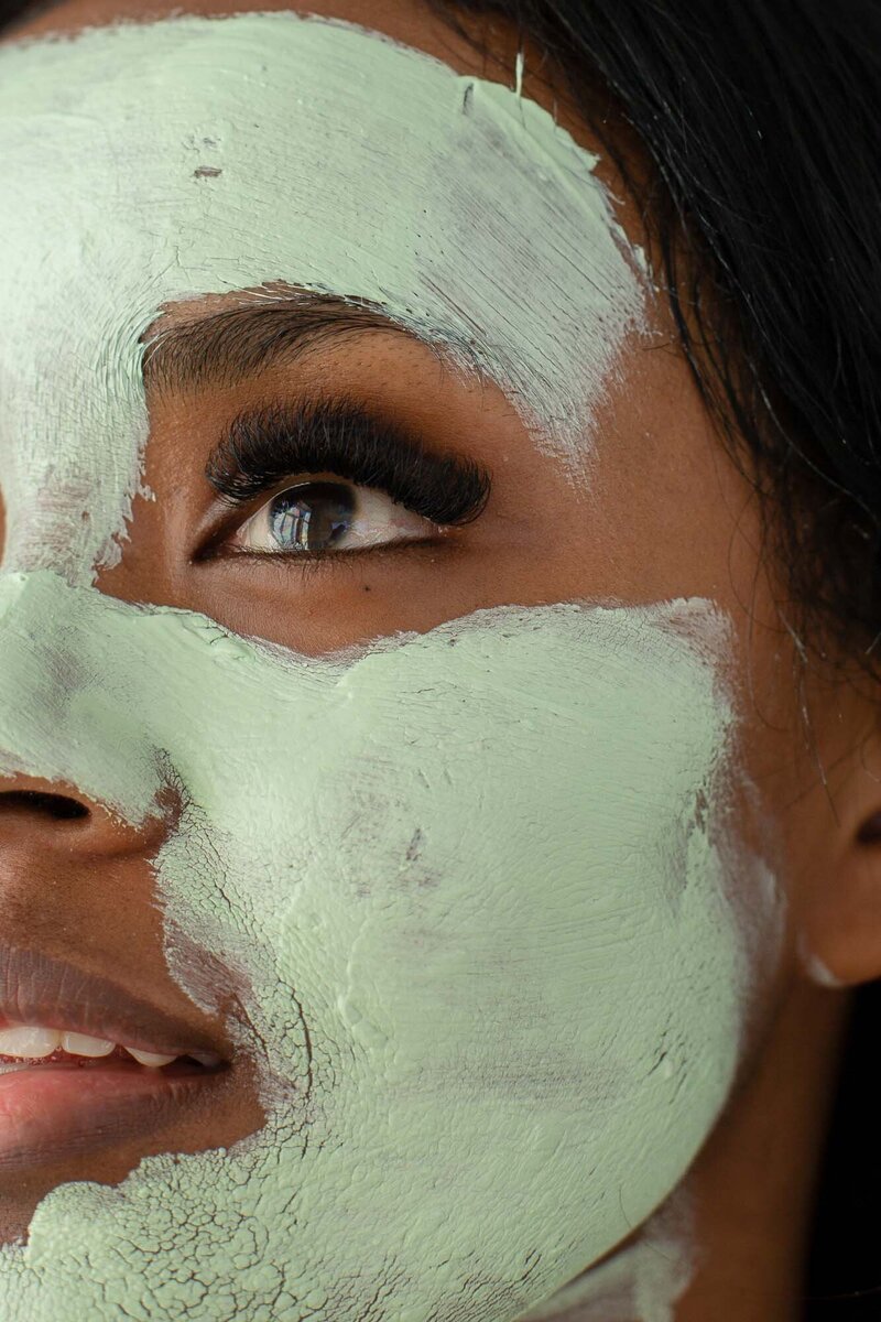 Close up on woman wearing green mud mask, St. Pete Rejuvenate CO2 Lift Mask Aesthetic Treatment