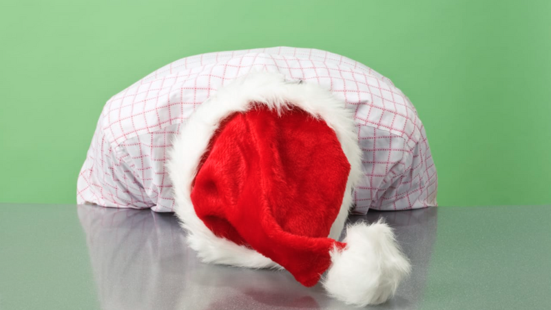 man in holiday garb sits frustrated