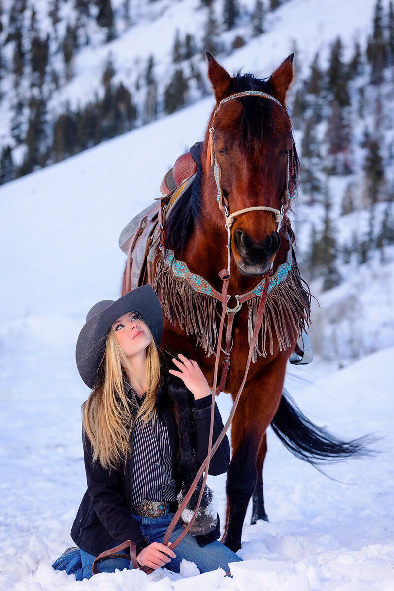 unique high school senior photo session with horse in the snow