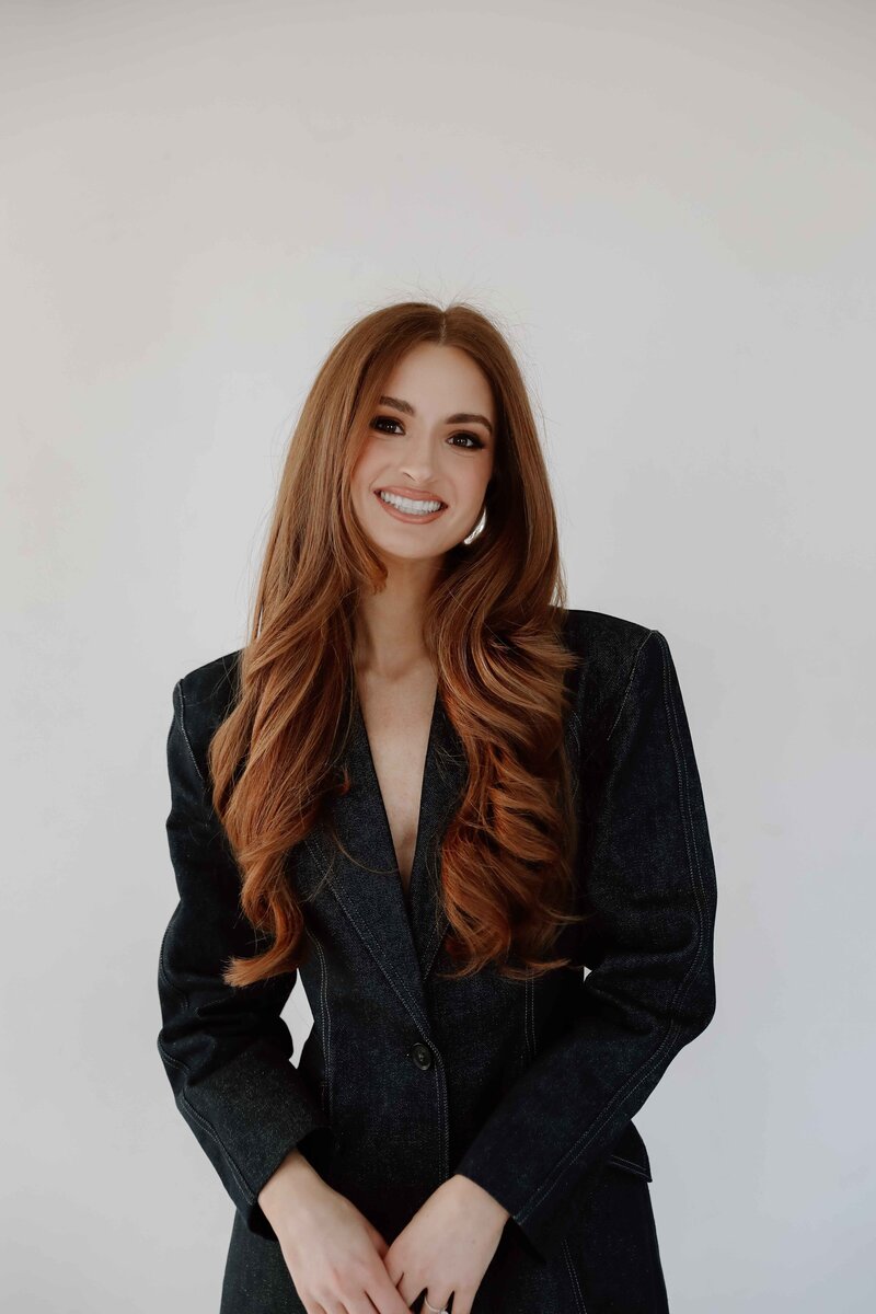 Natalie Jones in a blue jean suit smiling in a branding headshot