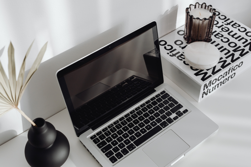 Flat lay of a laptop on a modern desk workspace, representing digital marketing work, video editing, and content creation at Graceful Exposure Media.