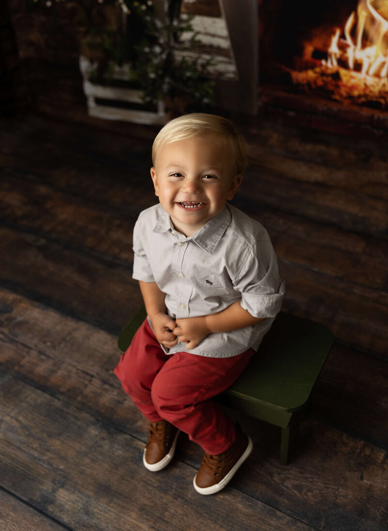Photo of a little boy sitting on a stool